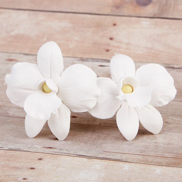Small African Orchids are gumpaste sugarflower cake decorations perfect as cake toppers for cake decorating fondant cakes and wedding cakes. Caljava wholesale cake supply.