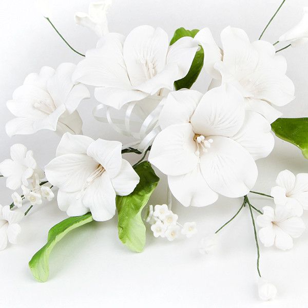 Open Lily Sprays in White are gumpaste sugarflower cake decorations perfect as cake toppers for cake decorating fondant cakes and wedding cakes. Caljava wholesale cake supply.