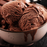 A scoop of rich, dark fudge brownie ice cream served in a waffle cone by lorann