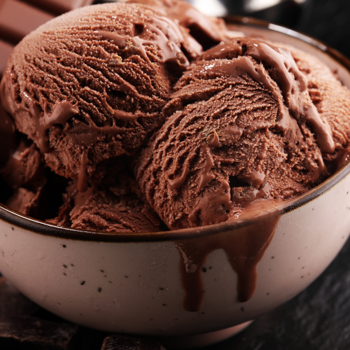 A scoop of rich, dark fudge brownie ice cream served in a waffle cone by lorann