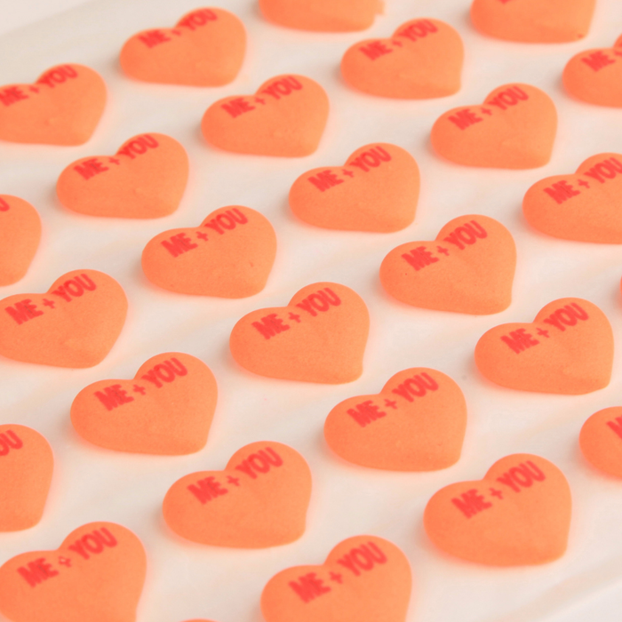 Time-saving ready-made icing toppers in conversation heart shapes for candy makers increasing efficiency and production