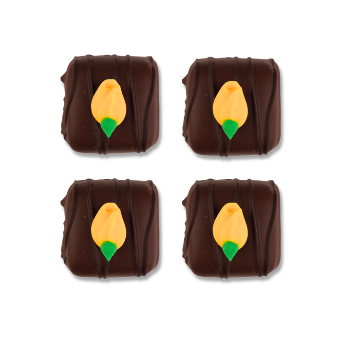 Yellow rosebud royal icing toppers by Caljava used to decorate chocolates, candy, cookies, donuts and desserts