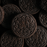 Close-up of fine, dark cocoa Amoretti Cookies and Cream cookie crumbs showing uniform grain texture.