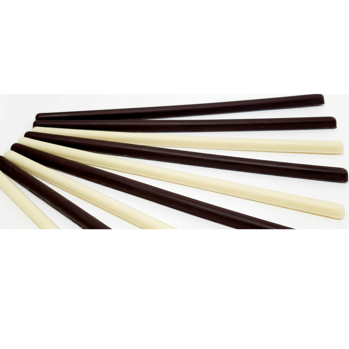 Dark chocolate and white chocolate skinny sticks for artisan pastry decorations.