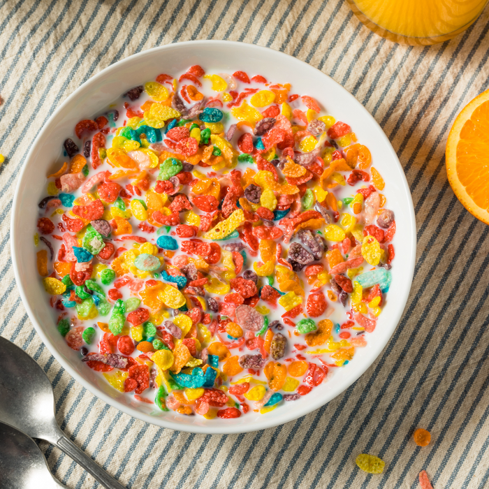 Fruity cereal milk ice cream sundae topped with whipped cream and crushed fruity cereal