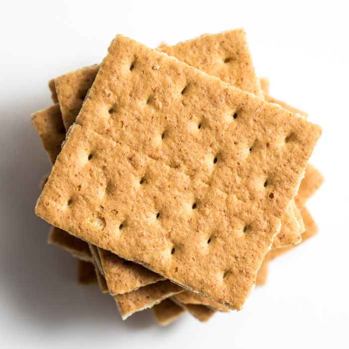 Pressed Amoretti Graham Cracker cookie crumb crust prepared in a springform pan for cheesecake.
