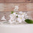 Pre-wired flexible stem on a white gumpaste orchid spray cake topper for easy cake placement.