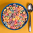 Scoop of pastel pink fruity cereal milk hard-packed ice cream served in a bowl