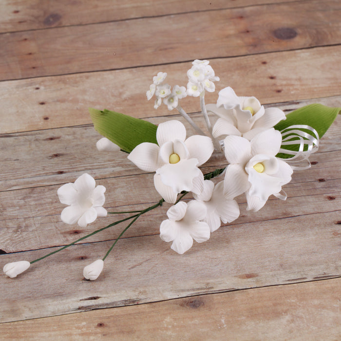 Box of 9 pre-wired white Singapore orchid sugar flower sprays for cake decorating.