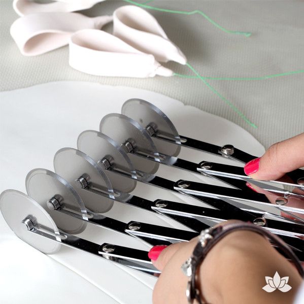 5 Ribbon Fondant Cutter has 6 adjustable blades which cut ribbons up to 5" wide, 5 ribbons at a time. Perfect for cake decorators who make ribbons & loops. Fondant Tool