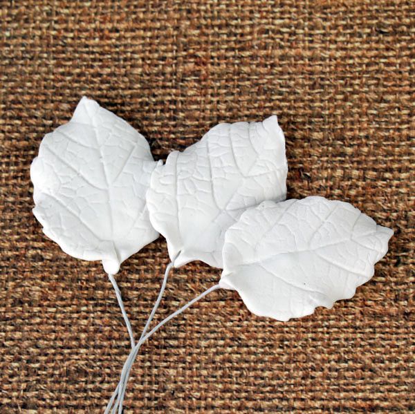 Close-up showing two sizes of green gum paste rose leaves with dimensions 2.5x1.75 inches and 1.5x1.25 inches with flexible wire stems. Wholesale cake supply by Caljava