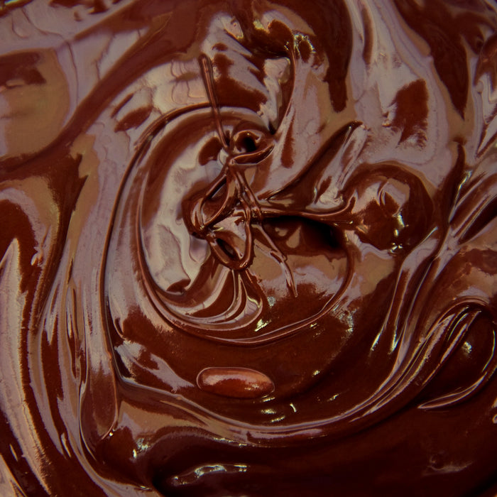 Ganaches are perfect when used as the center for your truffles, or they can be melted and used for frosting your creations or dipping cookies, biscotti, cake pops, and more. Shaving chocolate to make your own chocolate shavings.