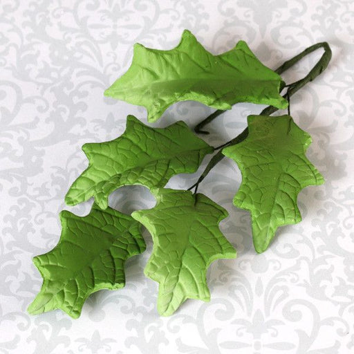Holly leaf sugarflower from gumpaste perfect for cake decorating fondant cakes and wedding cakes. Wholesale sugarflowers and cake supply.