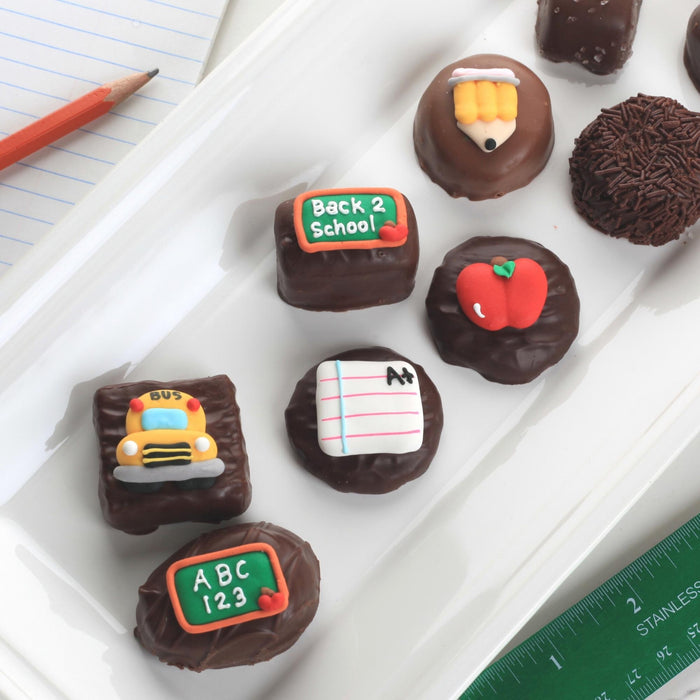Back to school chocolate gift set featuring dipped treats with edible pencil and chalkboard royal icing toppers.
