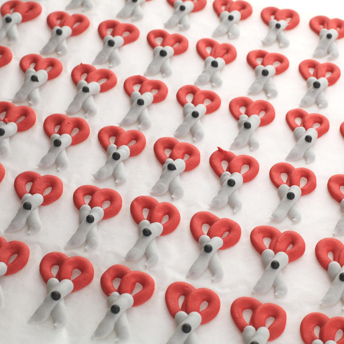 Assorted back-to-school royal icing toppers decorating artisan chocolate truffles to streamline confectionery output during peak back-to-school order rushes by Caljava