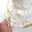 Multiple large white Cora peony gumpaste sugar flowers arranged together for tiered cake styling.