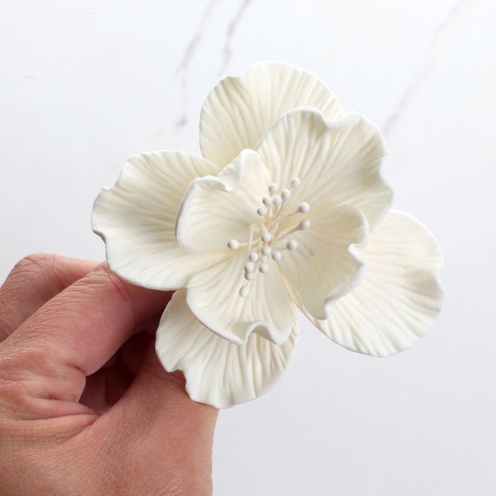 Close-up of a handcrafted 3.25-inch white Cora peony sugar flower showing detailed textured petals.Caljava