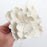 Single large white Cora peony gumpaste flower ready to place as a wedding cake topper.