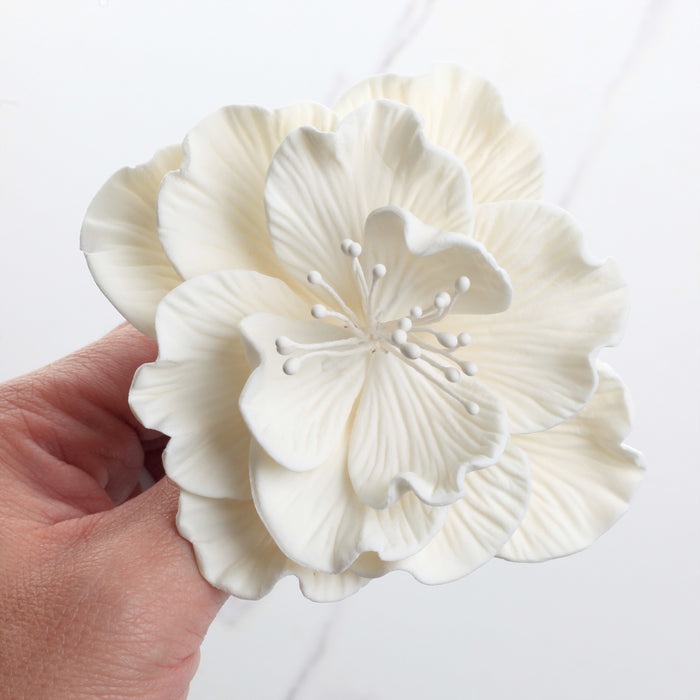 Single large white Cora peony gumpaste flower ready to place as a wedding cake topper.