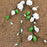 Handcrafted white and green gumpaste sweet pea sugar flower sprays on a burlap background for cake decorating by Caljava