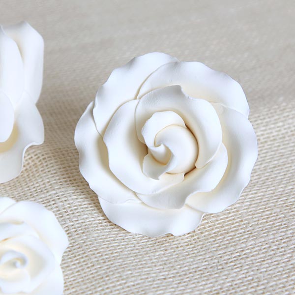 Assorted sizes of white English rose sugar flowers including 2-inch, 3-inch, and 4-inch gumpaste toppers