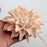 Close-up view of a realistic peach gumpaste dahlia flower featuring detailed handcrafted petals and a flexible wired stem.Wholesale sugarflower. Caljava Bakery Supplies