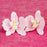 Close-up of handcrafted pink gumpaste orchid blooms showing intricate petals and realistic details.