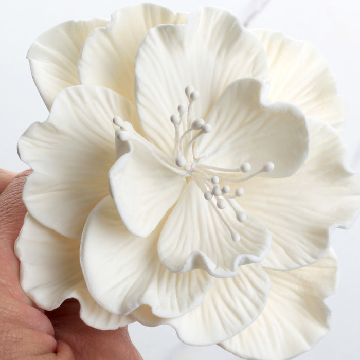 Pre-wired bendable stem on a large white Cora peony gumpaste flower for easy positioning on cakes.