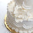 Pre-wired bendable stem on a white Cora peony gumpaste flower for easy cake positioning.