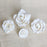 Handcrafted white English garden rose sugar flowers arranged on a multi-tiered fondant wedding cake.