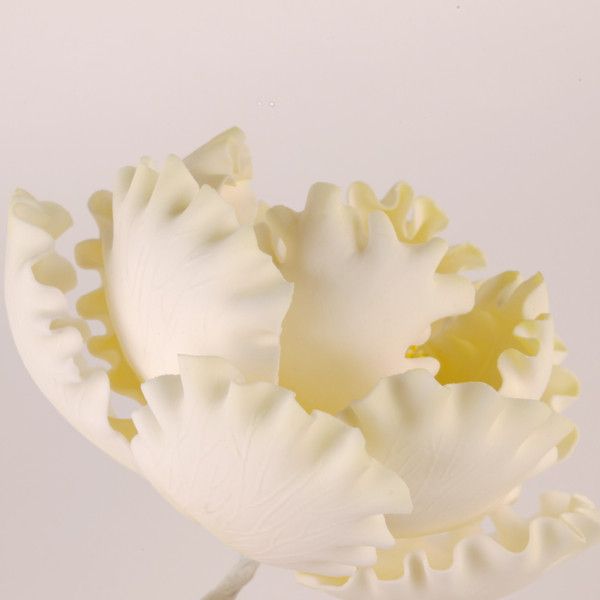Yellow peony gumpaste sugar flower decorating a buttercream cake design